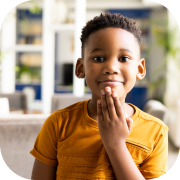 Child making a sign language handshape.