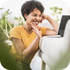 Woman signing while using a laptop.